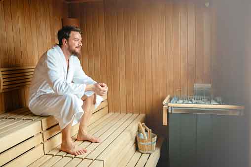 Man sits in sauna